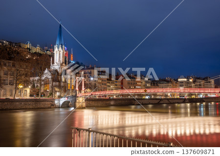 Lyon, france. December 29, 2023. Evening view of lyon, france, showing the illuminated saint georges church, passerelle saint georges bridge, and saone river 137609871