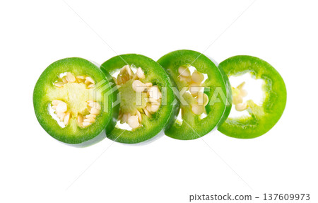 Fresh jalapeno pepper isolated on white background. Slices of green hot serrano pepper. Clipping path. Top view. Fresh jalapeno pepper isolated on white background. Slices of green hot serrano pepper. Clipping path. Top view. 137609973