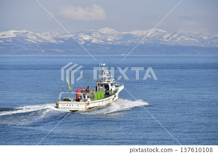 Photographing a fishing boat leaving Ochibe Fishing Port in Yakumo Town, Hokkaido in early spring Photographing a fishing boat leaving Ochibe Fishing Port in Yakumo Town, Hokkaido in early spring 137610108