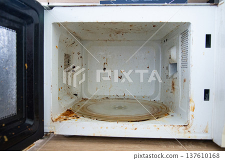 Dirty old microwave oven interior 137610168