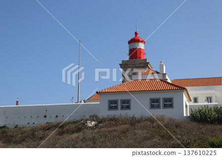 Red lighthouse tower and traditional white buildings at Cabo da Roca, Portugal. Red lighthouse tower and traditional white buildings at Cabo da Roca, Portugal. 137610225