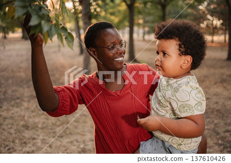 Mother and child exploring nature in a park, enjoying quality time together 137610426