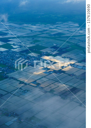 A rural landscape of rice paddies in early summer seen from an airplane A rural landscape of rice paddies in early summer seen from an airplane 137610690