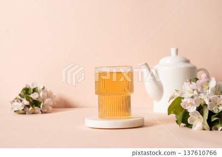 Herbal tea glass with teapot and apple blossom flowers Herbal tea glass with teapot and apple blossom flowers 137610766