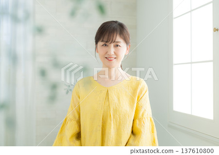 A woman in her 60s by the window 137610800