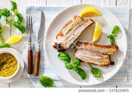 Roasted pork belly ribs with pesto and lemon Roasted pork belly ribs with pesto and lemon 137610905