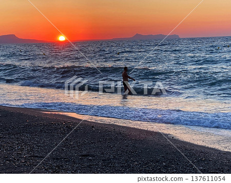 summer sunset on the sea coast in Creta, Greece, at 02 August 2023. Beautiful sunset by the sea in a beach on Kreta. Fantastic sunset on the Mediterranean Crete 137611054