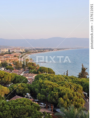 Picturesque view of turkey coast, Kusadasi, Audin, blue sea and mountain on horizon in mist. Calm water surface, background for traveling and vacation, Beautiful sea view, sea in sunny day. 137611091