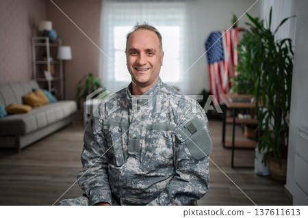 American soldier smiling at home with united states flag American soldier smiling at home with united states flag 137611613