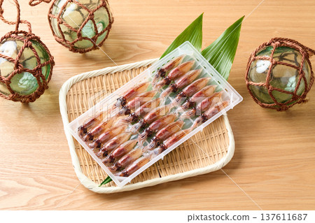 Raw firefly squid lined up in a case 137611687