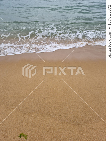 It is a beach with waves crashing in It is a beach with waves crashing in 137611872
