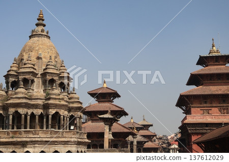 A view of the cityscape of Patan in Kathmandu, Nepal with blue sky, stupas and brick buildings A view of the cityscape of Patan in Kathmandu, Nepal with blue sky, stupas and brick buildings 137612029