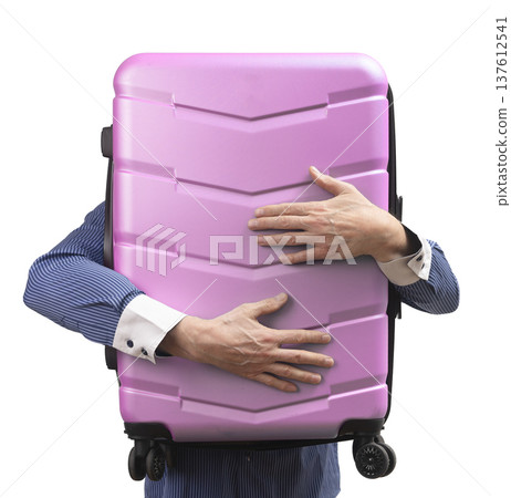 Business man holding suitcase, hiding behind. Business traveler in shirt embraces giant wheeled Business man holding suitcase, hiding behind. Business traveler in shirt embraces giant wheeled 137612541