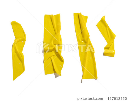 Set of yellow adhesive tape strips with wrinkles, folds, and glossy surface texture. Abstract sticky 137612550
