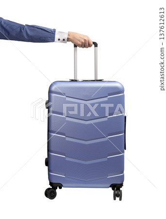 Hand holding suitcase. Business traveler with wheeled hardshell carry-on, gripping telescopic handle Hand holding suitcase. Business traveler with wheeled hardshell carry-on, gripping telescopic handle 137612613