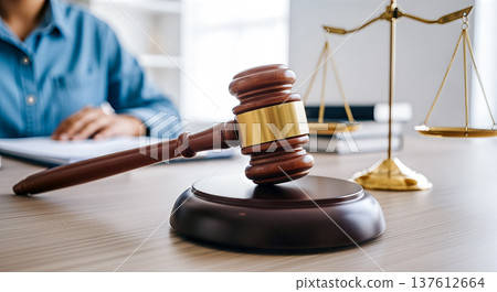 Wooden gavel resting desk golden scales justice background, blurred lawyer judge working documents, legal system court law order legal advice jurisprudence concept Wooden gavel resting desk golden scales justice background, blurred lawyer judge working documents, legal system court law order legal advice jurisprudence concept 137612664