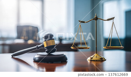 Wooden gavel resting desk beside golden scales justice modern blurred office background legal system court law order jurisprudence attorney advice concept Wooden gavel resting desk beside golden scales justice modern blurred office background legal system court law order jurisprudence attorney advice concept 137612669