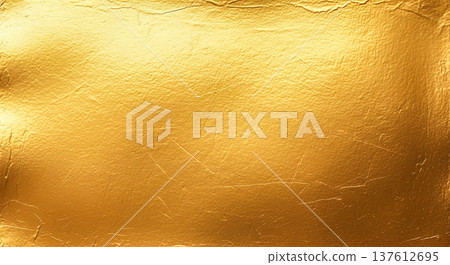 Luxurious shiny gold leaf foil texture showing detailed scratched metallic surface pattern for premium elegant background design and artistic holiday graphic decoration 137612695