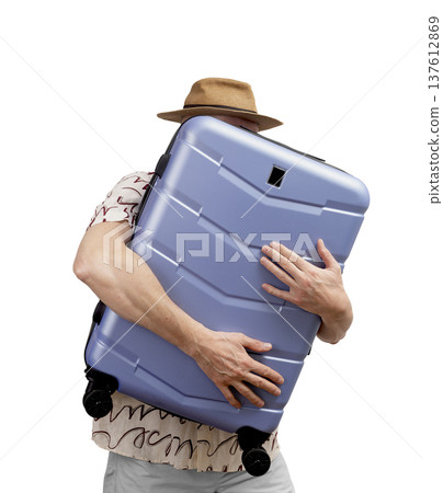 Man holding carry-on. tourist in summer hat embraces big wheeled suitcase, ready for airline journey Man holding carry-on. tourist in summer hat embraces big wheeled suitcase, ready for airline journey 137612869