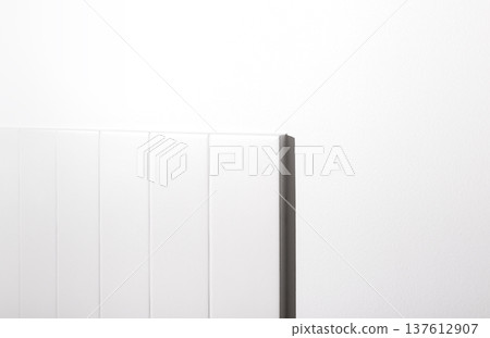 Minimal white interior detail with modern til backsplash against smooth off-white painted wall. Minimal white interior detail with modern til backsplash against smooth off-white painted wall. 137612907