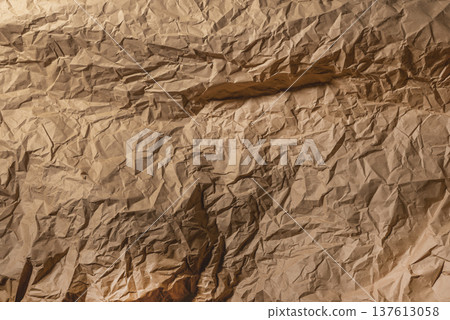 Crumpled brown kraft paper texture background. Wrinkled packaging sheet abstract surface detail. Rustic craft material backdrop concept.. 137613058