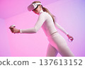 Woman in VR glasses against neon background 137613152