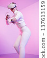 Female in VR glasses practicing martial arts in studio 137613159