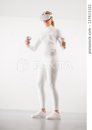 Female in VR glasses practicing martial arts at studio 137613161