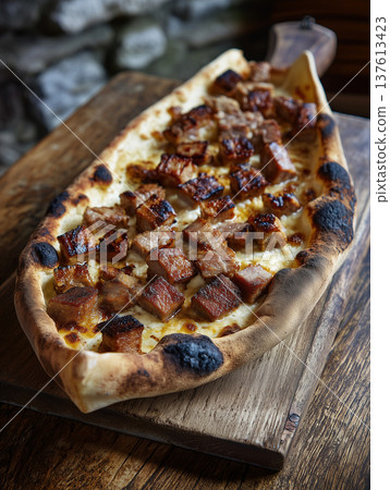 Traditional Macedonian Pastrmajlija, Canoe-Shaped Bread with Salted Meat Cubes Traditional Macedonian Pastrmajlija, Canoe-Shaped Bread with Salted Meat Cubes 137613423