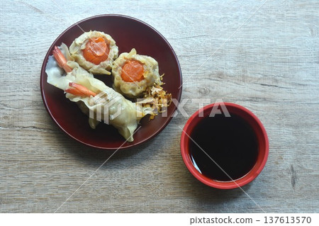 steamed Chinese dumpling stuffing shrimp and chop pork with salty egg on plate dipping soy sauce steamed Chinese dumpling stuffing shrimp and chop pork with salty egg on plate dipping soy sauce 137613570