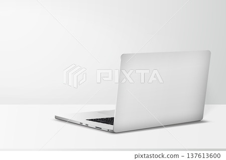 Minimal workspace with laptop back side view on table with gray wall background. Minimal workspace with laptop back side view on table with gray wall background. 137613600