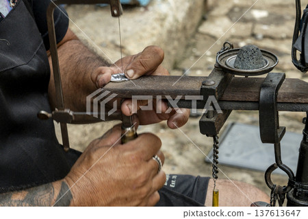 Close up on hands of street artist working in a colonial style street in Brazil 137613647