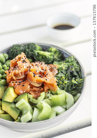 smoked salmon and green vegetable healthy poke bowl on white table in melbourne australia cafe smoked salmon and green vegetable healthy poke bowl on white table in melbourne australia cafe 137613786