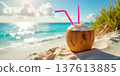 Coconut drink on beach with turquoise ocean waves. 137613885