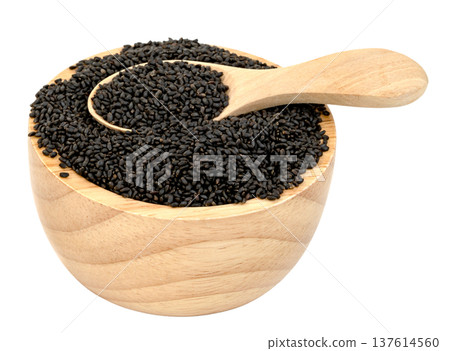 Sweet basil seeds in a small wooden bowl with a wooden spoon isolated. Raw black sabja seeds for healthy drinks and dessert topping. High angle view of natural organic ingredient. Sweet basil seeds in a small wooden bowl with a wooden spoon isolated. Raw black sabja seeds for healthy drinks and dessert topping. High angle view of natural organic ingredient. 137614560