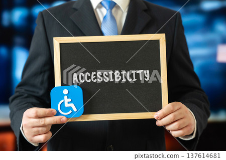 Board with the word Accessibility and an icon of a person with a disability, symbolizing inclusion, equal access, social responsibility, human rights, diversity, support, and accessibility for all. 137614681
