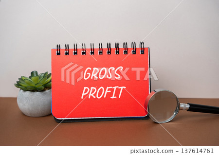 Concept of gross profit. Revenue minus cost of goods sold, business finance, accounting. Business and finance. Notepad and magnifying glass Concept of gross profit. Revenue minus cost of goods sold, business finance, accounting. Business and finance. Notepad and magnifying glass 137614761