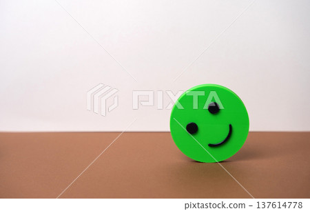 Smiling green face emotion. The concept of good mood and mental health. Optimism, happiness, maintain a balanced mindset. Stress relief, mindfulness practices. Successful review and satisfied customer Smiling green face emotion. The concept of good mood and mental health. Optimism, happiness, maintain a balanced mindset. Stress relief, mindfulness practices. Successful review and satisfied customer 137614778