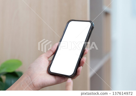 Screen Display. Close-up of hand holding smartphone with empty screen for customization. Screen Display. Close-up of hand holding smartphone with empty screen for customization. 137614972