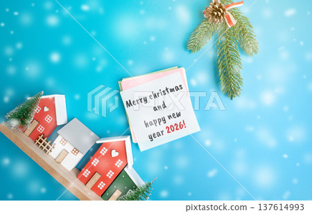 Greeting card Merry Christmas and Happy New Year 2026. Xmas winter holiday. Decoration, celebration. The concept of the beginning of the new year. Christmas tree and houses with snowfall Greeting card Merry Christmas and Happy New Year 2026. Xmas winter holiday. Decoration, celebration. The concept of the beginning of the new year. Christmas tree and houses with snowfall 137614993