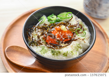 Egg yolk pickled in salted kelp on top of grated yam rice, garnished with wasabi Egg yolk pickled in salted kelp on top of grated yam rice, garnished with wasabi 137615071