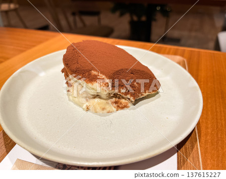 Creamy tiramisu cake sprinkled with cocoa powder. Creamy tiramisu cake sprinkled with cocoa powder. 137615227