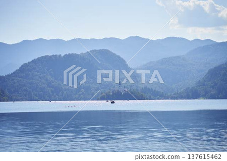 Scenic panoramic view of Lake Bled with the island church and mountains in the background Scenic panoramic view of Lake Bled with the island church and mountains in the background 137615462