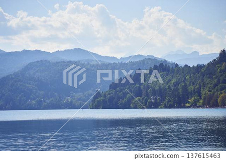 Scenic panoramic view of Lake Bled with the island church and mountains in the background Scenic panoramic view of Lake Bled with the island church and mountains in the background 137615463