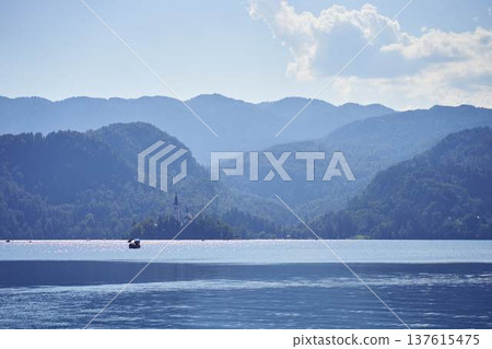 Scenic panoramic view of Lake Bled with the island church and mountains in the background Scenic panoramic view of Lake Bled with the island church and mountains in the background 137615475