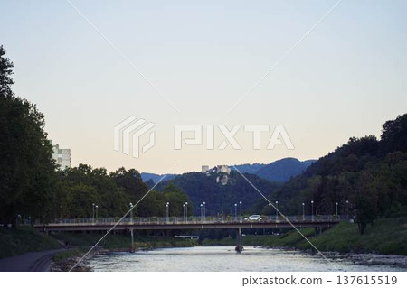 Scenic view of the Savinja river embankment with the old castle of Celje on the hill Scenic view of the Savinja river embankment with the old castle of Celje on the hill 137615519