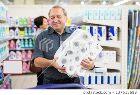 Mature man choosing packaged piece of meat in grocery store Mature man choosing packaged piece of meat in grocery store 137615689