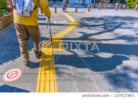 Yokohama cityscape, Japan: An elderly man with a walking stick... A black shadow sways on the dangerous sidewalk... What is life... = Yokohama City (Yokohama Station West Exit) 137615861