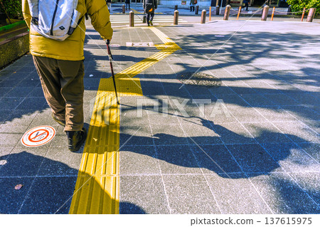 Yokohama cityscape, Japan: An elderly man with a walking stick... A black shadow sways on the dangerous sidewalk... What is life... = Yokohama City (Yokohama Station West Exit) Yokohama cityscape, Japan: An elderly man with a walking stick... A black shadow sways on the dangerous sidewalk... What is life... = Yokohama City (Yokohama Station West Exit) 137615975