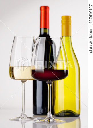 Different wine bottles and glasses on white background Different wine bottles and glasses on white background 137616137
